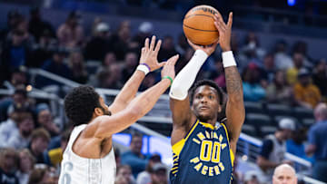 Mar 19, 2025; Indianapolis, Indiana, USA; Indiana Pacers guard Bennedict Mathurin (00) shoots the ball while Dallas Mavericks guard Spencer Dinwiddie (26) defends in the first half at Gainbridge Fieldhouse. Mandatory Credit: Trevor Ruszkowski-Imagn Images