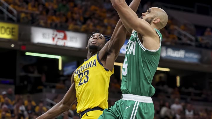 May 27, 2024; Indianapolis, Indiana, USA; Boston Celtics guard Derrick White (9) attempts a layup while Indiana Pacers forward Aaron Nesmith (23) blocks during the third quarter during game four of the eastern conference finals for the 2024 NBA playoffs at Gainbridge Fieldhouse. Mandatory Credit: Trevor Ruszkowski-USA TODAY Sports