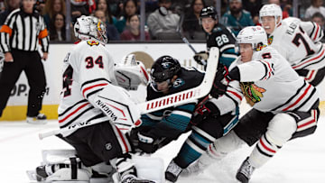Oct 31, 2024; San Jose, California, USA; San Jose Sharks center Luke Kunin (11) collides with Chicago Blackhawks goaltender Petr Mrazek (34) during the second period at SAP Center at San Jose. Mandatory Credit: D. Ross Cameron-Imagn Images
