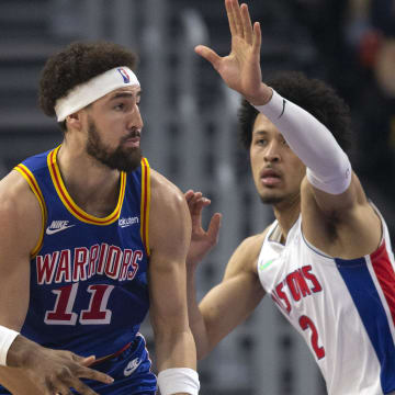 Jan 18, 2022; San Francisco, California, USA; Detroit Pistons guards Hamidou Diallo (left) and Cade Cunningham (2) harass Golden State Warriors guard Klay Thompson (11) during the first quarter at Chase Center. Mandatory Credit: D. Ross Cameron-USA TODAY Sports