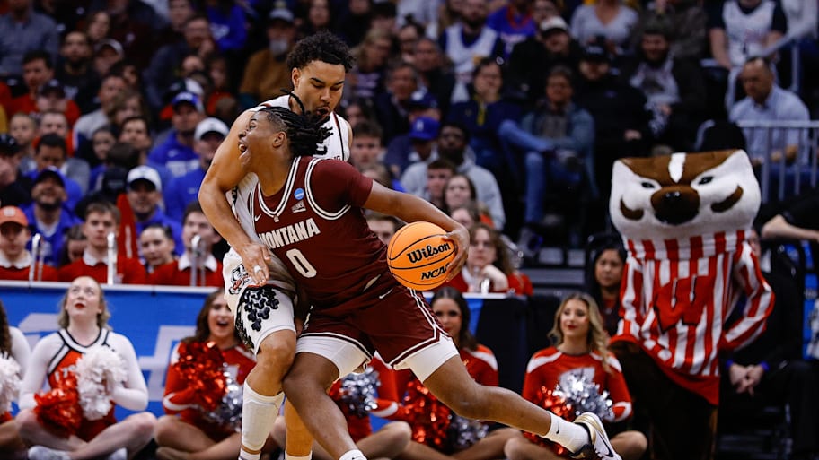 Wisconsin guard John Tonje defends against Montana guard Money Williams.