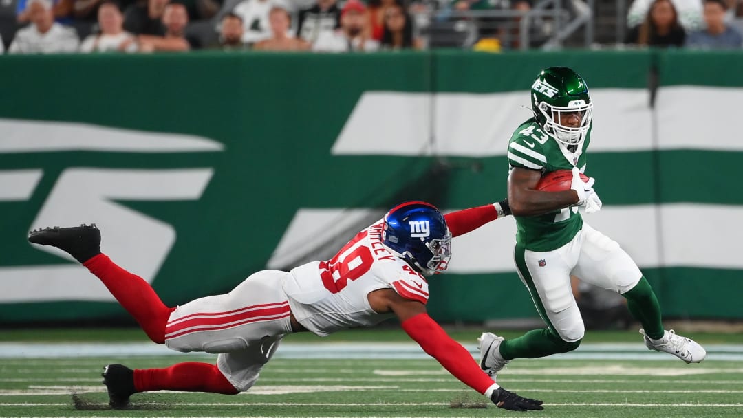 Aug 24, 2024; East Rutherford, New Jersey, USA; New York Jets cornerback Brandon Codrington (43) returns a punt as New York Giants linebacker Benton Whitley (48) defends during the first half at MetLife Stadium. Mandatory Credit: Rich Barnes-USA TODAY Sports