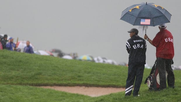 Tiger Woods looks on as the rain falls during the 2010 Ryder Cup
