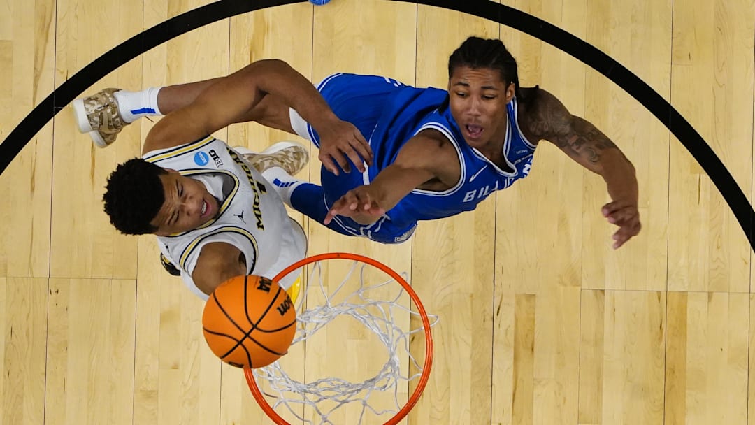 Mar 21, 2026; Buffalo, NY, USA; Saint Louis Billikens guard Kellen Thames (0) shoots a layup against Michigan Wolverines guard Trey McKenney (1) during the first half of the second round game of the men's 2026 NCAA Tournament at Keybank Center. Mandatory Credit: Gregory Fisher-Imagn Images