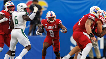 Aug 29, 2025; Lawrence, Kansas, USA; Kansas Jayhawks running back Daniel Hishaw Jr. (9) runs the ball during the first half against the Wagner Seahawks  at David Booth Kansas Memorial Stadium. Mandatory Credit: William Purnell-Imagn Images