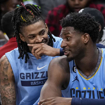 Mar 26, 2023; Atlanta, Georgia, USA; Memphis Grizzlies guard Ja Morant (12) and forward Jaren Jackson Jr. (13) react ons the bench during the game against the Atlanta Hawks during the second half at State Farm Arena. 