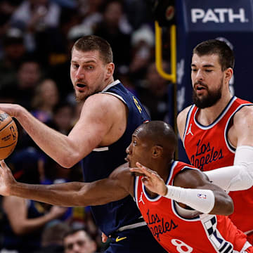 Los Angeles Clippers guard Kris Dunn (8) attempts to steal the ball away from Denver Nuggets center Nikola Jokic (15) as center Ivica Zubac (40) defends in the second quarter at Ball Arena. Mandatory Credit: Isaiah J. Downing-Imagn Images