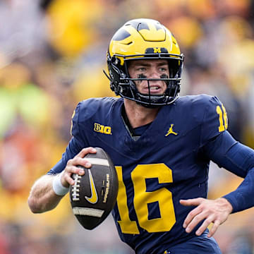 Michigan quarterback Davis Warren (16) looks to makes a pass against Texas linebacker Barryn Sorrell (88) during the second half at Michigan Stadium in Ann Arbor on Saturday, September 7, 2024.