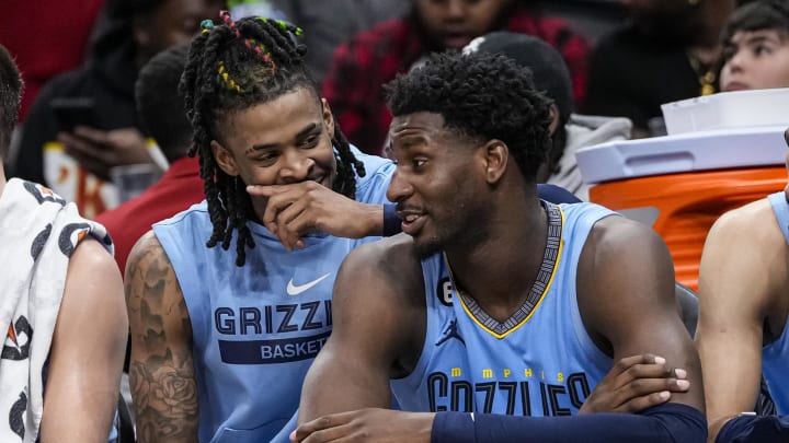 Mar 26, 2023; Atlanta, Georgia, USA; Memphis Grizzlies guard Ja Morant (12) and forward Jaren Jackson Jr. (13) react ons the bench during the game against the Atlanta Hawks during the second half at State Farm Arena. 