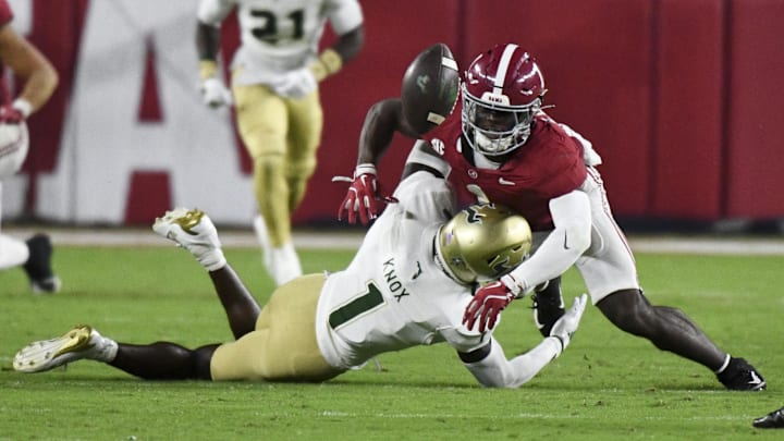 Sep 7, 2024; Tuscaloosa, Alabama, USA;  South Florida Bulls cornerback Ben Knox (1) forces a fumble by Alabama Crimson Tide wide receiver Kendrick Law (1) on a kick return at Bryant-Denny Stadium. Alabama won 42-16. 