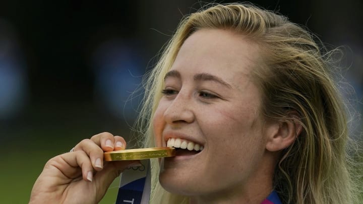 Aug 7, 2021; Tokyo, Japan; Nelly Korda (USA) celebrates with her gold medal on the podium after the final round of the women's individual stroke play of the Tokyo 2020 Olympic Summer Games at Kasumigaseki Country Club. Mandatory Credit: Michael Madrid-USA TODAY Sports