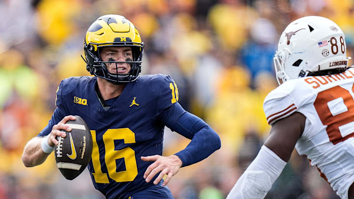 Michigan quarterback Davis Warren (16) looks to makes a pass against Texas linebacker Barryn Sorrell (88) during the second half at Michigan Stadium in Ann Arbor on Saturday, September 7, 2024.