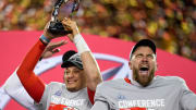 Chiefs quarterback Patrick Mahomes raises the Lamar Hunt Trophy with tight end Travis Kelce after the AFC championship game in January 2023.