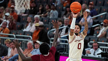 Nov 18, 2025; Austin, Texas, USA; Texas Longhorns guard Jordan Pope (0) shoots a three point basket against Rider Broncs guard Jamir McNeil (5) during the second half at Moody Center. Mandatory Credit: Dustin Safranek-Imagn Images