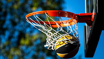 An Iowa basketball falls through the basket during the Hawkeye Hoops from Downtown event with the men's and women's basketball programs, Friday, Sept. 30, 2022, on Iowa Avenue in Iowa City, Iowa.

220930 Hoops Downtown 013 Jpg