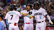 Jun 27, 2023; Phoenix, Arizona, USA; Arizona Diamondbacks outfielder Corbin Carroll (7) celebrates with teammates Geraldo Perdomo (2) and Ketel Marte after hitting a three run home run in the first inning against the Tampa Bay Rays at Chase Field. Mandatory Credit: Mark J. Rebilas-Imagn Images