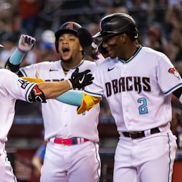 Jun 27, 2023; Phoenix, Arizona, USA; Arizona Diamondbacks outfielder Corbin Carroll (7) celebrates with teammates Geraldo Perdomo (2) and Ketel Marte after hitting a three run home run in the first inning against the Tampa Bay Rays at Chase Field. Mandatory Credit: Mark J. Rebilas-Imagn Images