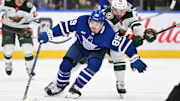 Jan 29, 2025; Toronto, Ontario, CAN;  Toronto Maple Leafs   forward Nick Robertson (89) skates with the puck against Minnesota Wild forward Devin Shore (19) in the first period at Scotiabank Arena. Mandatory Credit: Dan Hamilton-Imagn Images