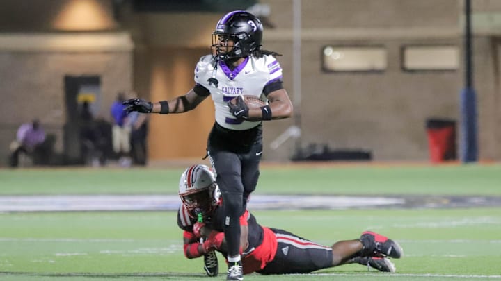 Calvary's Jalen Hicks unsuccessfully attempts to pull away from a Jenkins High defender on Friday, September 19, 2025 at Memorial Stadium.