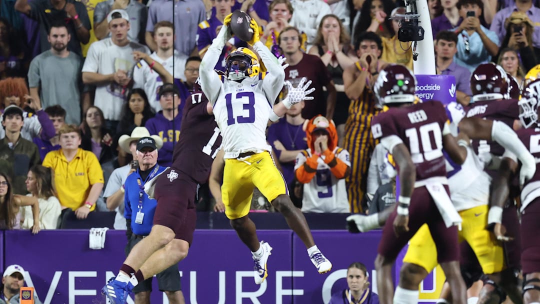 Oct 25, 2025; Baton Rouge, Louisiana, USA; Louisiana State Tigers defensive back A.J. Haulcy (13) makes an interception against Texas A&M Aggies tight end Theo Melin Öhrström (17) during the first half at Tiger Stadium. Mandatory Credit: Stephen Lew-Imagn Images Oct 25, 2025; Baton Rouge, Louisiana, USA; Louisiana State Tigers defensive back A.J. Haulcy (13) makes an interception against Texas A&M Aggies tight end Theo Melin Öhrström (17) during the first half at Tiger Stadium. Mandatory Credit: Stephen Lew-Imagn Images