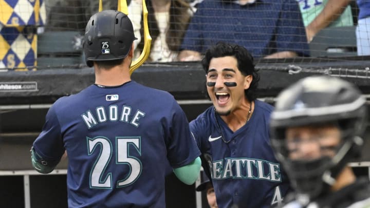 Seattle Mariners shortstop Dylan Moore (25) celebrates with third baseman Josh Rojas after hitting a home run against the Chicago White Sox on Friday.