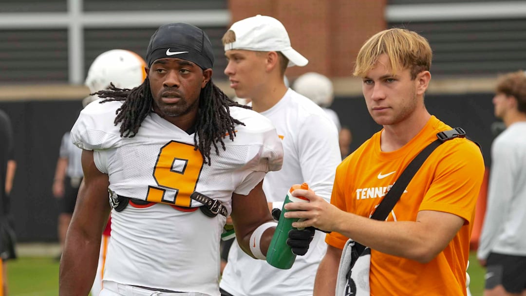 Tennessee running back Star Thomas (9) takes a water bottle from a trainer during Tennessee football preseason practice, in Knoxville, Tennessee, Aug. 6, 2025.