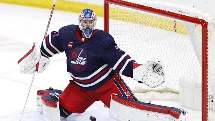 Mar 30, 2024; Winnipeg, Manitoba, CAN; Ottawa Senators left wing Brady Tkachuk (7) (not shown) scores on Winnipeg Jets goaltender Connor Hellebuyck (37) in the third period at Canada Life Centre. Mandatory Credit: James Carey Lauder-Imagn Images