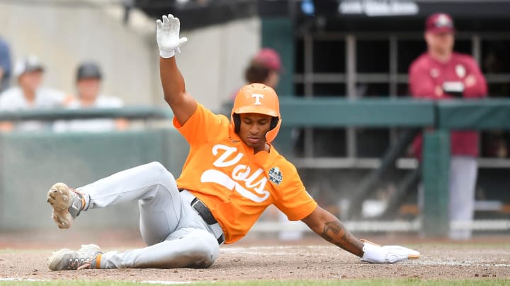 Tennessee's Christian Moore (1) slides home safely during a NCAA College World Series game between Tennessee and Florida State at Charles Schwab Field in Omaha, Neb., on Wednesday, June 19, 2024.