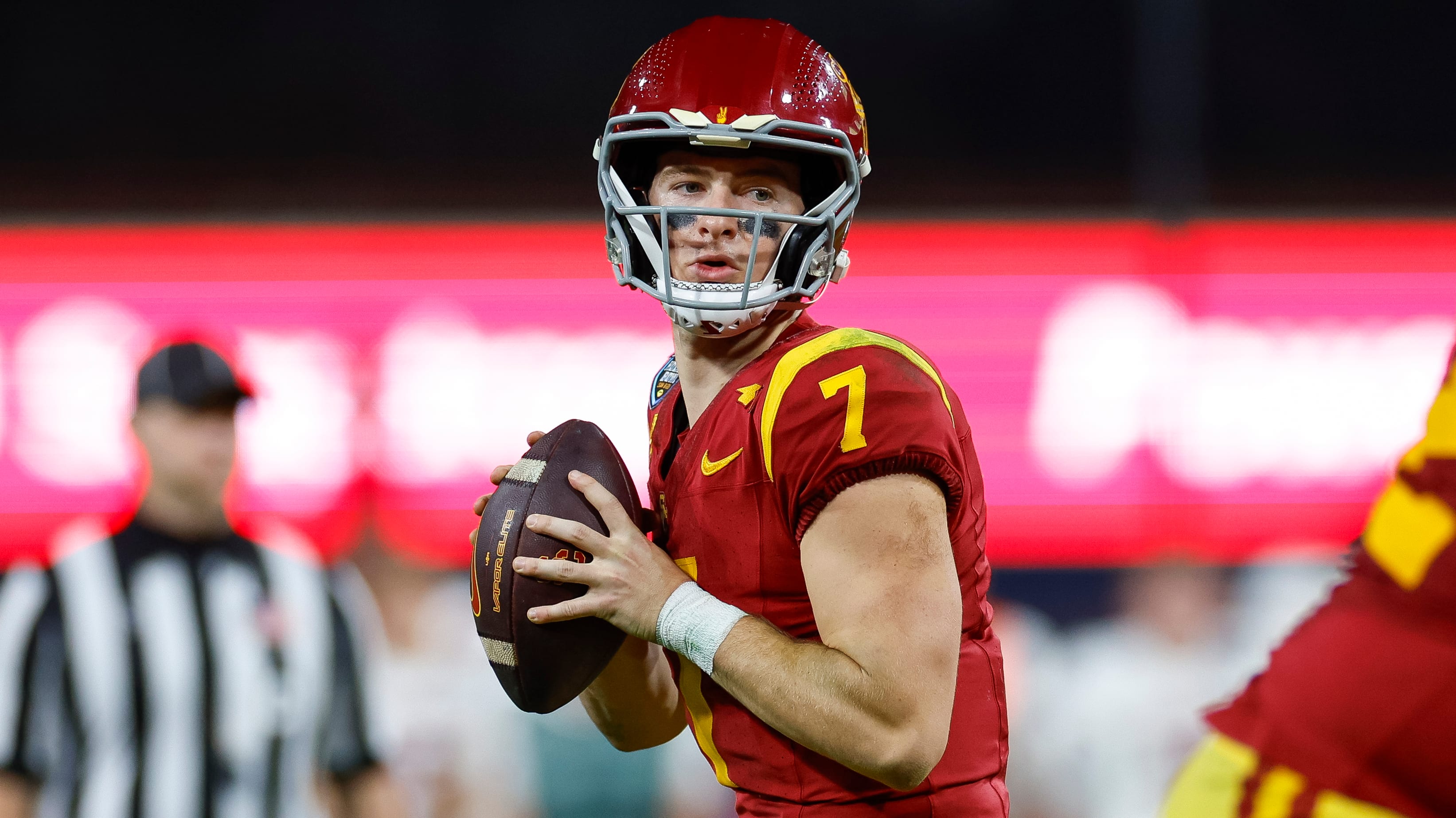 USC Trojans quarterback Miller Moss attempts a pass during a college football game.