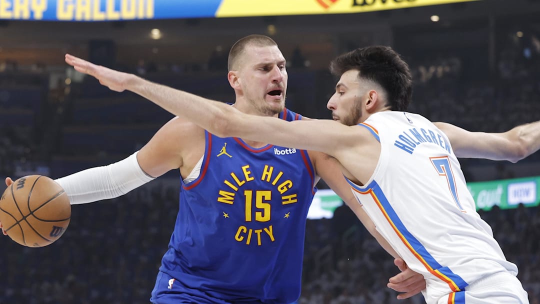 May 13, 2025; Oklahoma City, Oklahoma, USA; Denver Nuggets center Nikola Jokic (15) is defended by Oklahoma City Thunder forward Chet Holmgren (7) on a drive during the first quarter of game five of the second round for the 2025 NBA Playoffs at Paycom Center.