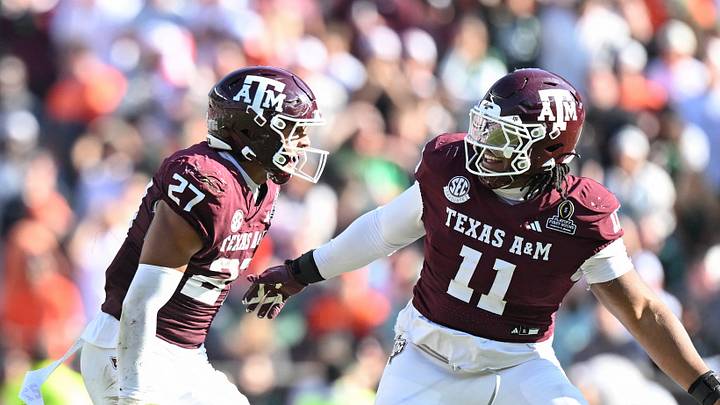 Dec 20, 2025; College Station, TX, USA; Texas A&M Aggies linebacker Daymion Sanford (27) reacts with defensive tackle Tyler Onyedim (11) after recovering a fumble against the Miami Hurricanes during the second half of the first round game of the CFP National Playoff at Kyle Field. Mandatory Credit: Maria Lysaker-Imagn Images