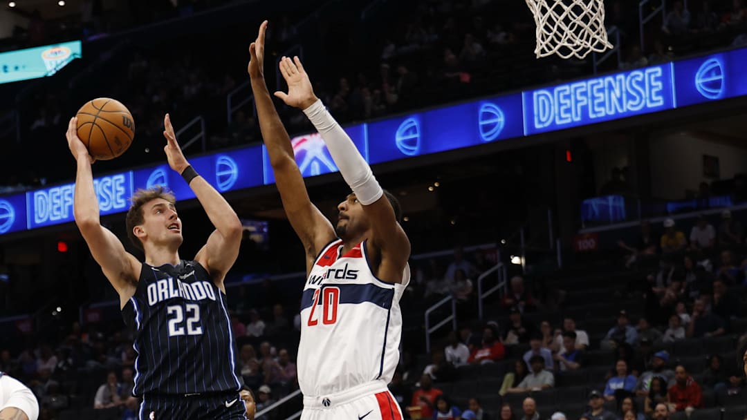 Apr 3, 2025; Washington, District of Columbia, USA; Orlando Magic forward Franz Wagner (22) shoots the ball as Washington Wizards forward Alex Sarr (20) defends in the first half at Capital One Arena. Mandatory Credit: Geoff Burke-Imagn Images