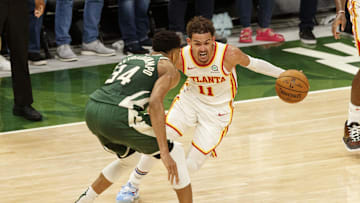 Jun 23, 2021; Milwaukee, Wisconsin, USA;  Atlanta Hawks guard Trae Young (11) drives for the basket against Milwaukee Bucks forward Giannis Antetokounmpo (34) during the fourth quarter during game one of the Eastern Conference Finals for the 2021 NBA Playoffs at Fiserv Forum. Mandatory Credit: Jeff Hanisch-Imagn Images
