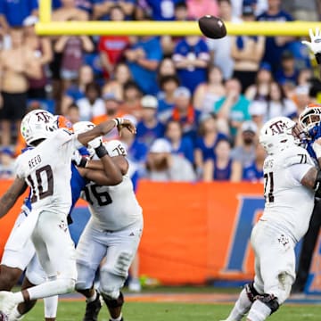 Sep 14, 2024; Gainesville, Florida, USA; Texas A&M Aggies quarterback Marcel Reed (10) throws over the hand of Florida Gators defensive end George Gumbs Jr. (34) during the first half at Ben Hill Griffin Stadium. Mandatory Credit: Matt Pendleton-Imagn Images