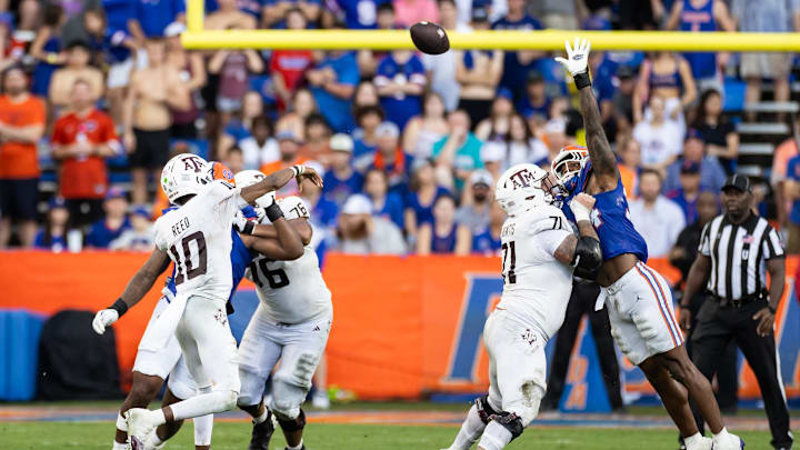 Sep 14, 2024; Gainesville, Florida, USA; Texas A&M Aggies quarterback Marcel Reed (10) throws over the hand of Florida Gators defensive end George Gumbs Jr. (34) during the first half at Ben Hill Griffin Stadium. Mandatory Credit: Matt Pendleton-Imagn Images