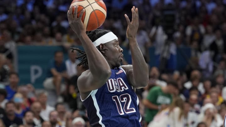 Jul 28, 2024; Villeneuve-d'Ascq, France; United States guard Jrue Holiday (12) passes in the first quarter against Serbia during the Paris 2024 Olympic Summer Games at Stade Pierre-Mauroy. Mandatory Credit: John David Mercer-USA TODAY Sports