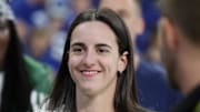 Oct 5, 2025; Indianapolis, Indiana, USA; Caitlin Clark looks on from the sideline during warmups before the game between the Las Vegas Raiders and the Indianapolis Colts at Lucas Oil Stadium. Mandatory Credit: Trevor Ruszkowski-Imagn Images
