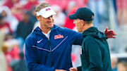 Oct 25, 2025; Norman, Oklahoma, USA;  Ole Miss Rebels head coach Lane Kiffin (left) speaks with Oklahoma Sooners head coach Brent Venables (right) before the game at Gaylord Family-Oklahoma Memorial Stadium. Mandatory Credit: Kevin Jairaj-Imagn Images