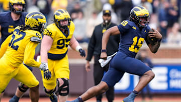 Team Blue quarterback Bryce Underwood (19) runs against Team Maize during the second half of the spring game at Michigan Stadium in Ann Arbor on Saturday, April 19, 2025.