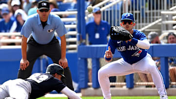 Yankees designated hitter Everson Pereira (93) dives back to first base as Toronto Blue Jays first baseman Cavan Biggio (8) waits for the ball in the second inning in a spring training game at TD Ballpark on Feb. 26, 2023.