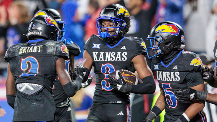 Nov 9, 2024; Kansas City, Missouri, USA; Kansas Jayhawks cornerback Mello Dotson (3) celebrates after scoring a touch down during the fourth quarter against the Iowa State Cyclones at GEHA Field at Arrowhead Stadium. Mandatory Credit: William Purnell-Imagn Images