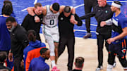 Boston Celtics forward Jayson Tatum is helped off the court after an injury fourth quarter of Game 4 of the Eastern Conference semifinals against the New York Knicks. 