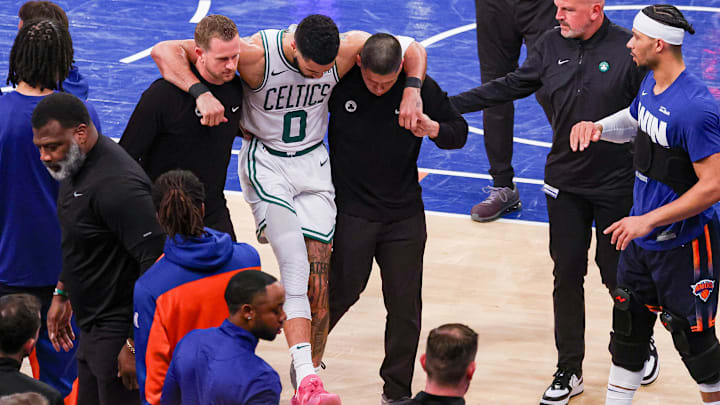 Boston Celtics forward Jayson Tatum is helped off the court after an injury fourth quarter of Game 4 of the Eastern Conference semifinals against the New York Knicks. 