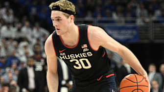 Feb 11, 2025; Omaha, Nebraska, USA;  Connecticut Huskies forward Liam McNeeley (30) dribbles against the Creighton Bluejays during the first half at CHI Health Center Omaha. Mandatory Credit: Steven Branscombe-Imagn Images