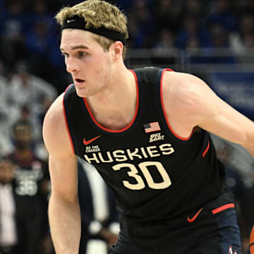Feb 11, 2025; Omaha, Nebraska, USA;  Connecticut Huskies forward Liam McNeeley (30) dribbles against the Creighton Bluejays during the first half at CHI Health Center Omaha. Mandatory Credit: Steven Branscombe-Imagn Images