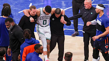 Boston Celtics forward Jayson Tatum is helped off the court by after an injury in the second half during game four of the second round for the 2025 NBA Playoffs against the New York Knicks at Madison Square Garden. 