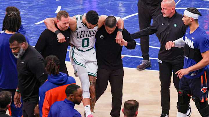 Boston Celtics forward Jayson Tatum is helped off the court by after an injury in the second half during game four of the second round for the 2025 NBA Playoffs against the New York Knicks at Madison Square Garden. Boston Celtics forward Jayson Tatum is helped off the court by after an injury in the second half during game four of the second round for the 2025 NBA Playoffs against the New York Knicks at Madison Square Garden.