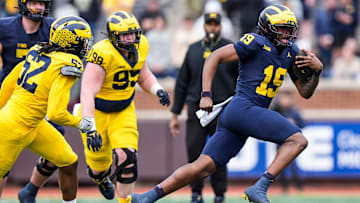 Team Blue quarterback Bryce Underwood (19) runs against Team Maize during the second half of the spring game at Michigan Stadium in Ann Arbor on Saturday, April 19, 2025.