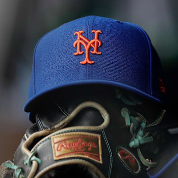 Aug 8, 2024; Denver, Colorado, USA; A New York Mets hat and glove in the dugout in the second inning against the Colorado Rockies at Coors Field. Mandatory Credit: Isaiah J. Downing-Imagn Images
