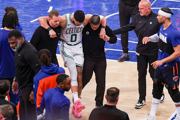 Boston Celtics forward Jayson Tatum is helped off the court by after an injury against the New York Knicks.